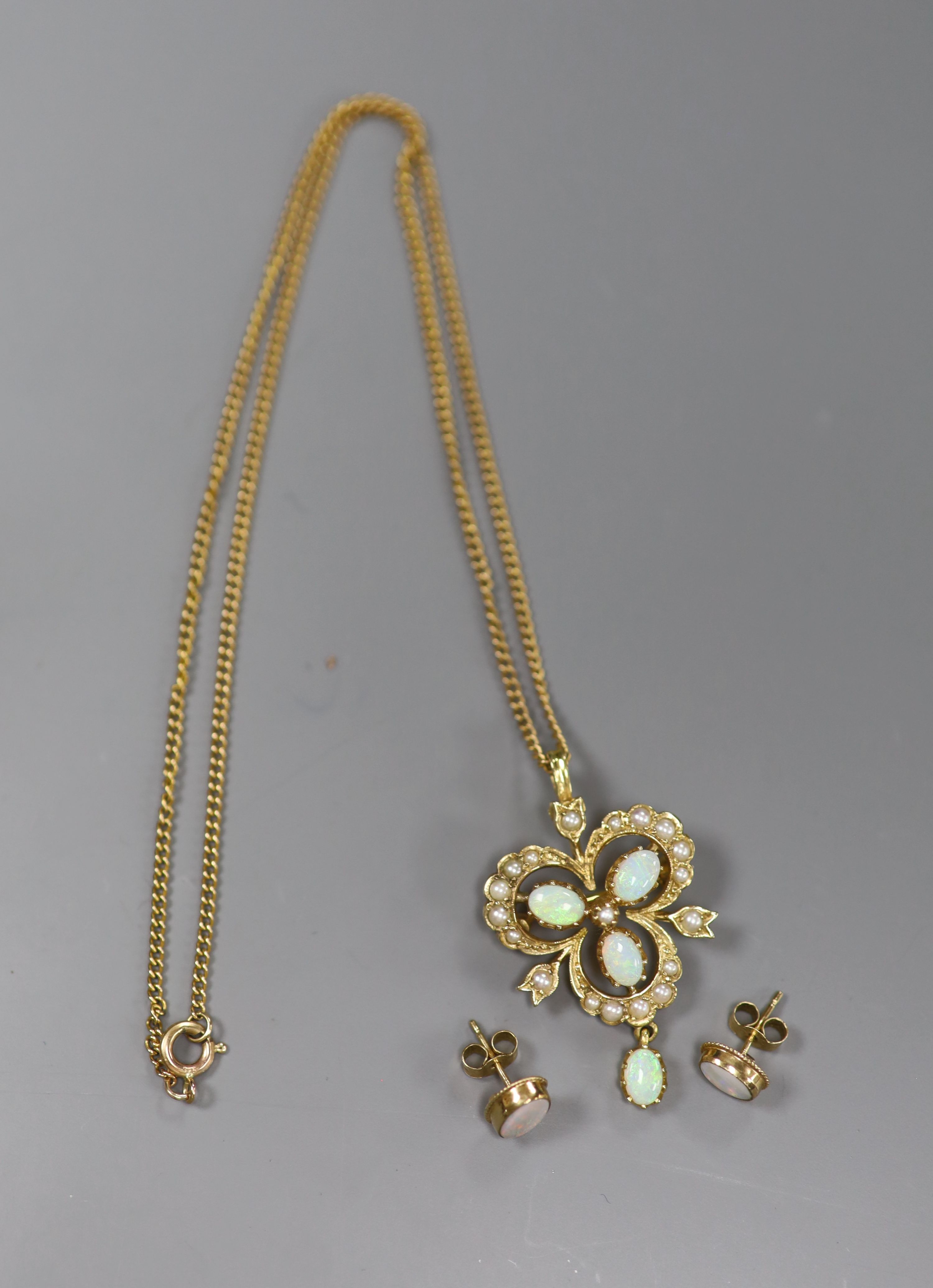 A modern 9ct gold, opal and seed pearl openwork drop pendant, on 9ct gold chain and a pair of opal 9ct stud earrings, gross 9.1g.